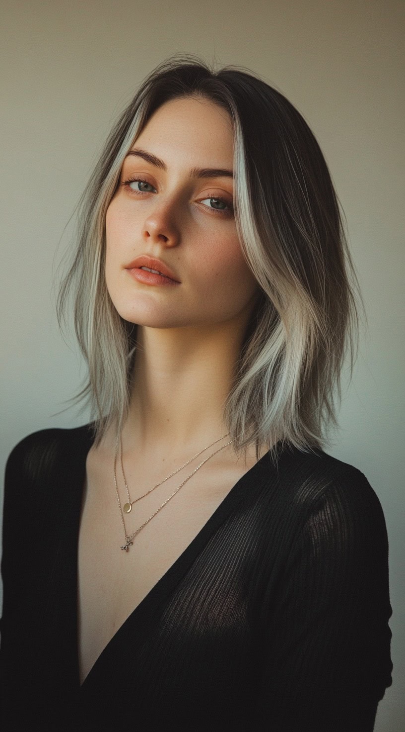 A woman with a textured mid-length bob featuring choppy layers and shadow roots for added depth and dimension.