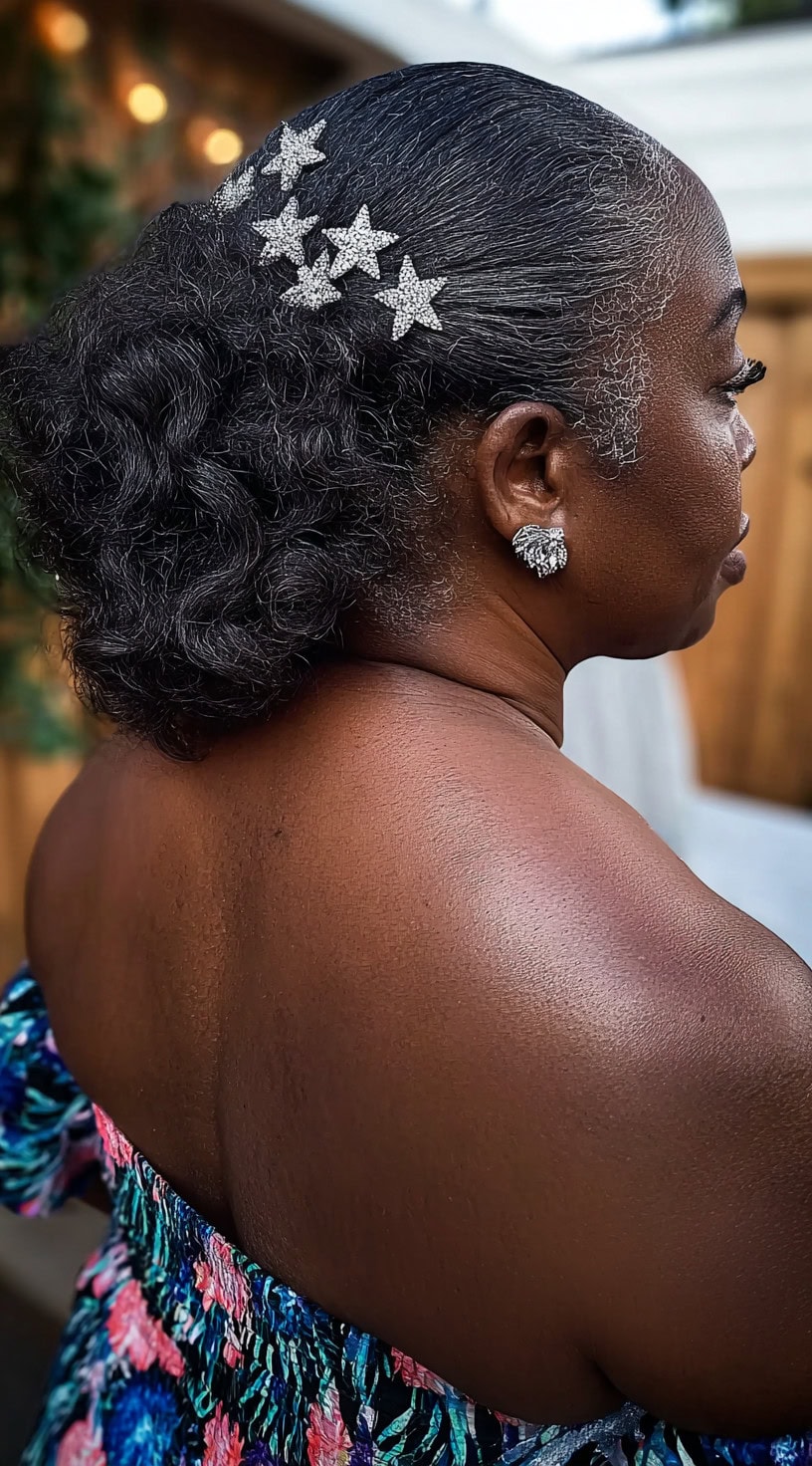 Woman with a textured low bun decorated with sparkling star-shaped hairpins.